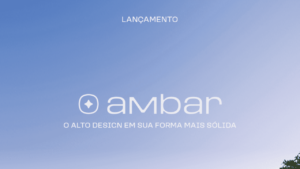 A imagem apresenta um fundo azul suave com a palavra "LANÇAMENTO" escrita na parte superior. No centro, encontra-se o logotipo da marca "Ambar," acompanhado do texto "O ALTO DESIGN EM SUA FORMA MAIS SÓLIDA." Na parte inferior direita, há uma silhueta parcial de árvores.